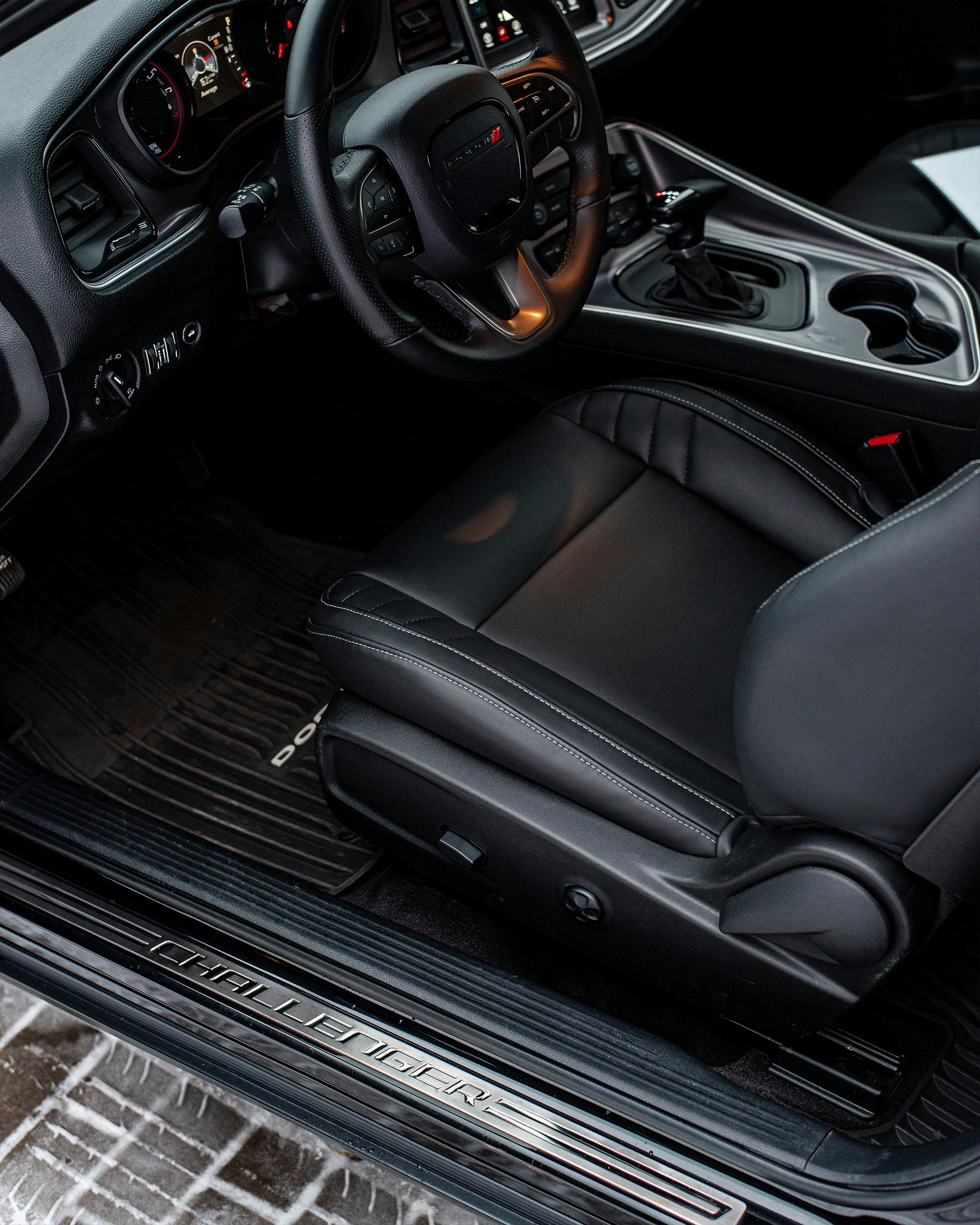 High-quality photo of a luxurious car interior featuring leather seats and detailed dashboard.